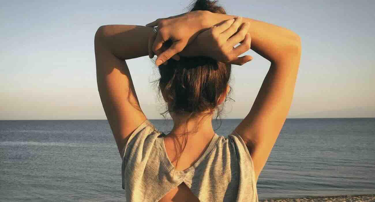 Natural summer hair care woman hair tied seaside vacation